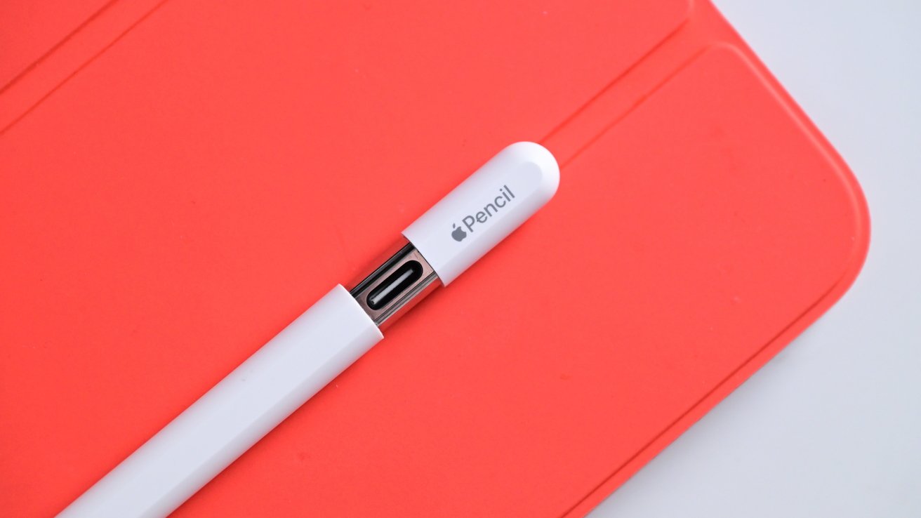 Apple Pencil with USB-C sits on an iPad's orange magnetic cover