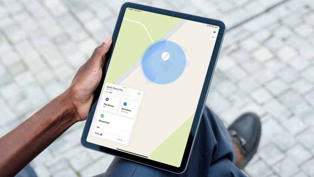 A person walking with an iPad in hand looking for an Apple Pencil in the Find My app