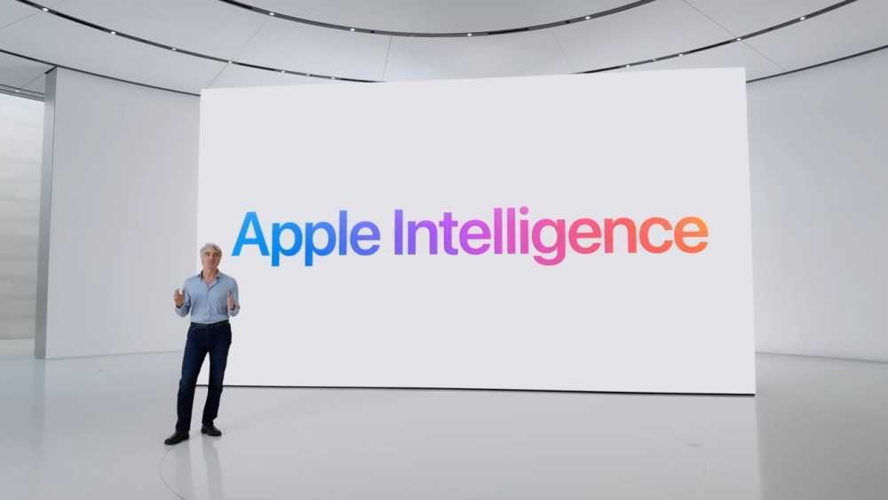 一个人站在现代化礼堂的舞台上，大屏幕上以彩色渐变显示着“Apple Intelligence”字样。