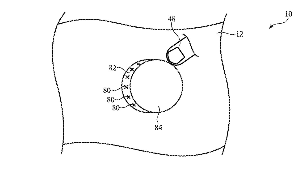 Line drawing of a circular object with numbers and a magnifying glass pointing to it on a wavy background.