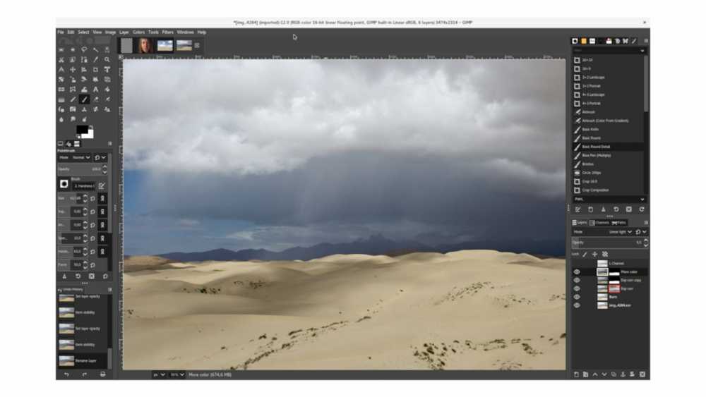 Photo editing software window showing a desert scene with sand dunes under a cloudy sky.