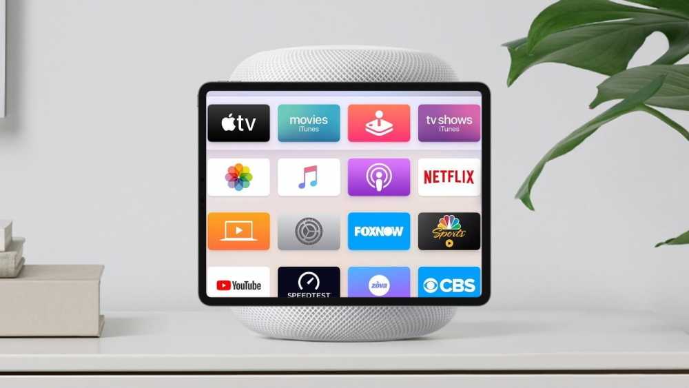 平板电脑显示流媒体应用图标，包括Apple TV、Netflix、YouTube等，放置在智能音箱旁边，音箱旁边有一株植物，背景是白色表面。