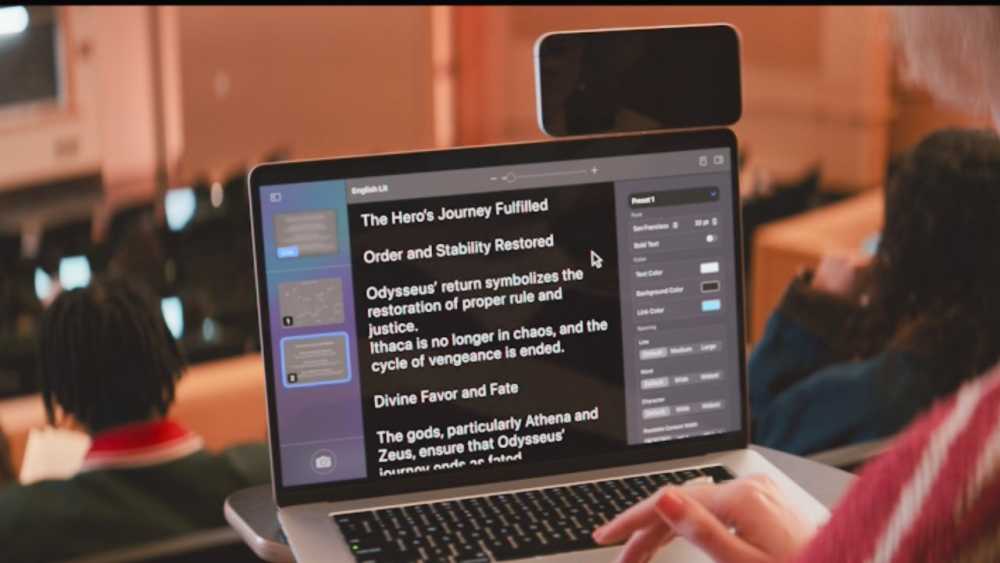 A person takes notes on a laptop in a lecture hall, displaying text about 'The Hero's Journey Fulfilled' and 'Order and Stability Re