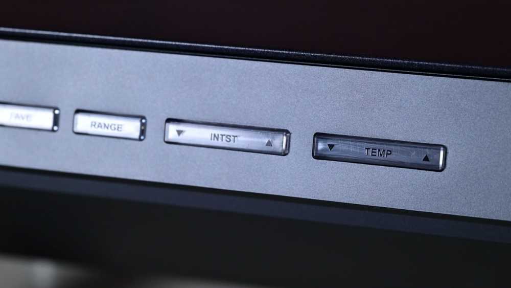 Four metal buttons on a panel labeled SAVE, RANGE, INST, TEMP, each with up and down arrows.