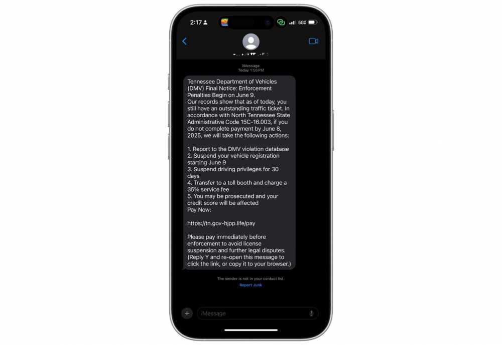 Phone displaying a suspicious text claiming to be from the Tennessee DMV, warning of unpaid ticket penalties and directing to a link for payment.