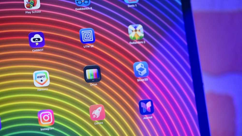 Colorful curved lines on a screen with various app icons such as Instagram, Games, and Shapr3D.