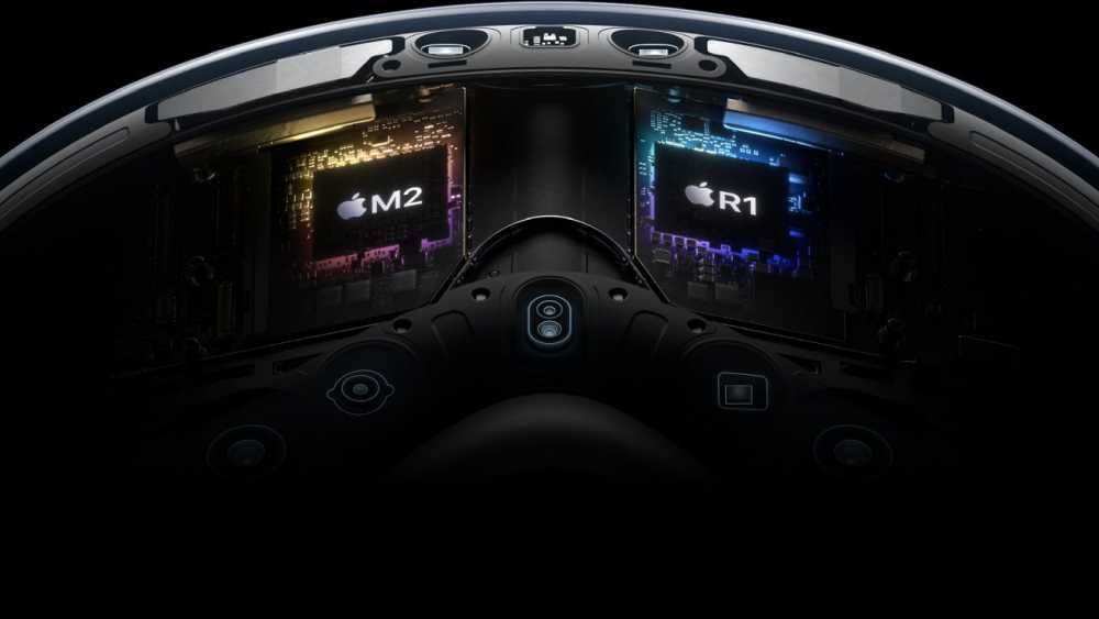 Interior view of a 头显 showing two Apple chips labeled M2 and R1, surrounded by circuitry and components.